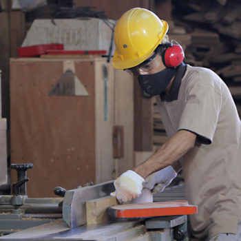 ymb-worker-cutting Cutting wood in our factory